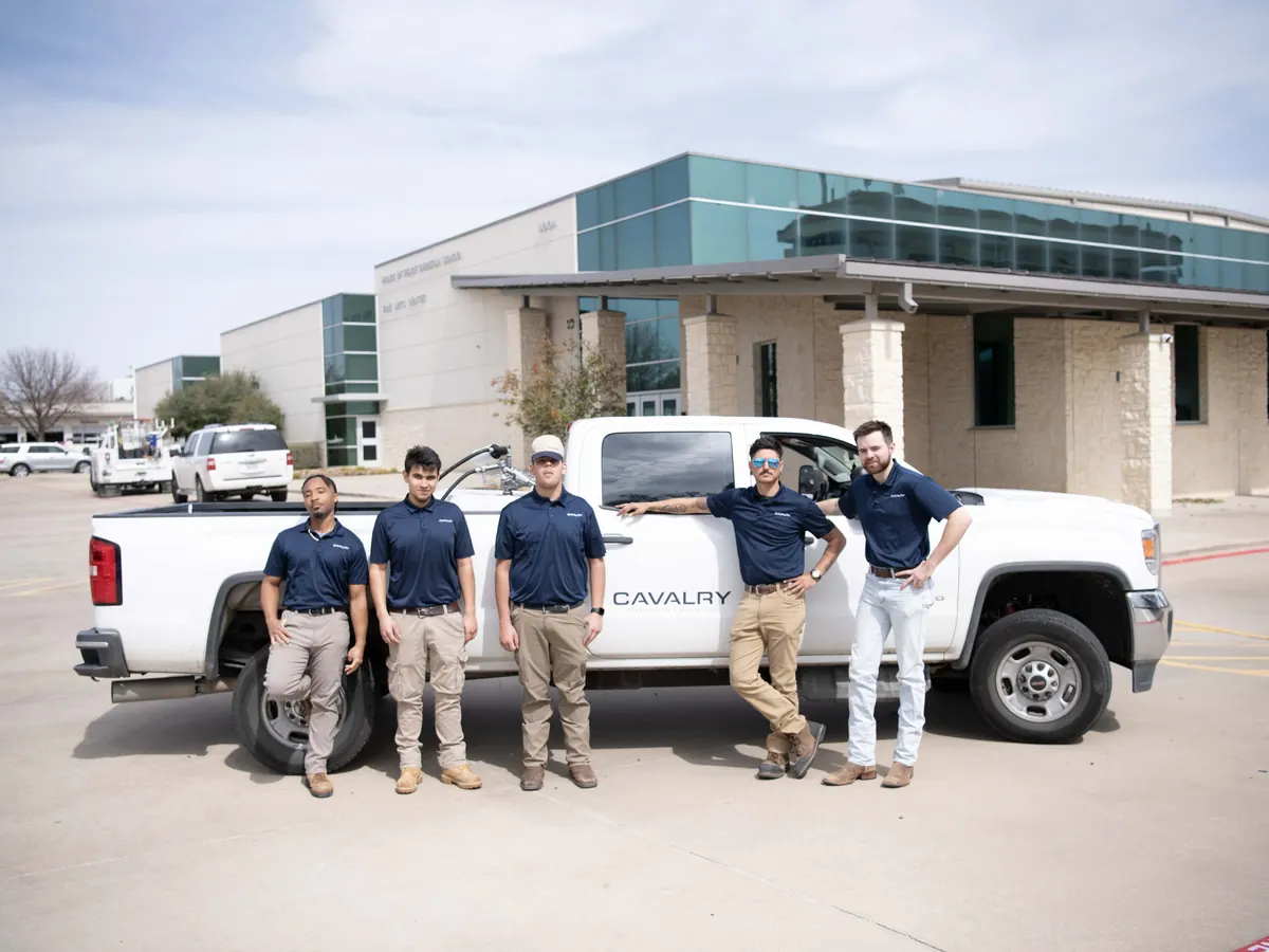Cavalry Construction & Restoration crew standing beside a company truck